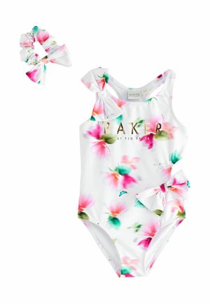 White floral toddler swimsuit with pink and green flowers, bows on shoulder and hip, and matching scrunchie hair tie.