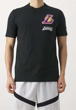 Black short-sleeve t-shirt made of cotton, featuring a purple and gold Los Angeles Lakers logo and white text on the front.