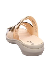Women's slide sandal featuring metallic gold synthetic upper, smooth beige footbed, and a cushioned midsole with a subtle platform design.