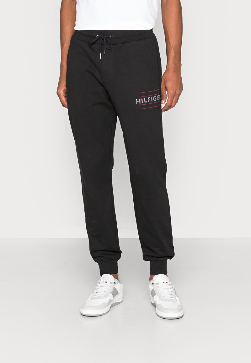 Tommy Hilfiger LINEAR FLAG Tracksuit bottoms black Zalando.co.uk
