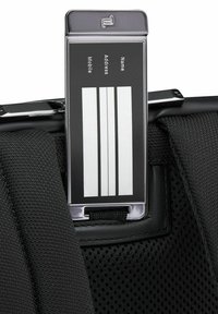 Black fabric luggage tag holder with a chrome finish. The tag features a clear window for personal information and white striped lines for writing.