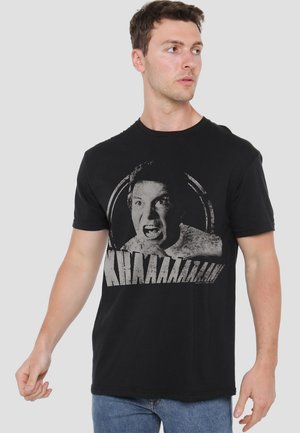 Black cotton t-shirt featuring a distressed print of a shouting face with large text below. Classic crew neckline and short sleeves.