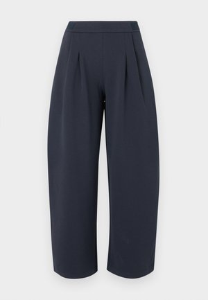 Pantalon large et court couleur bleu marine foncé avec taille haute et plis à l'avant, présenté sur un fond clair uni.