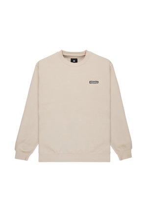Beige sweatshirt made from soft material, featuring a crew neck, ribbed cuffs, and a small black logo patch on the chest.