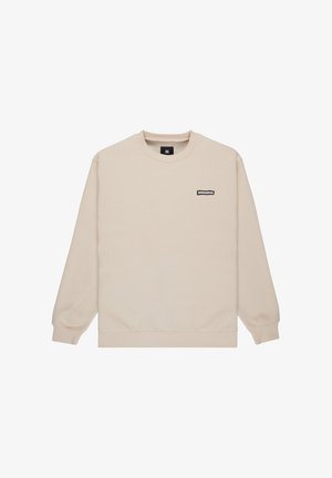Beige sweatshirt made from soft material, featuring a crew neck, ribbed cuffs, and a small black logo patch on the chest.