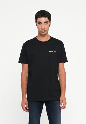T-shirt en coton noir avec col rond, manches courtes et logo "REPLAY" blanc sur la poitrine gauche. Coupe classique, texture lisse.