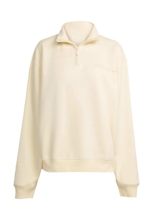 Beige quarter-zip sweatshirt with a high collar, long sleeves, and ribbed cuffs. Features an embroidered Adidas logo on the chest.