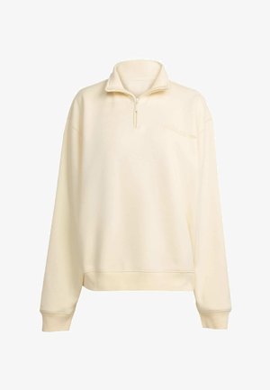 Beige värvi neljandik-zippiga sviiter kõrge kaeluse, pikkade varrukate ja soonikkudumisega mansettidega. Rinnal on tikitud Adidas'i logo.