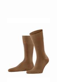 Braune Knöchelsocken in Knöchellänge mit einem gerippten Design, glatter Textur und verstärkter Zehenpartie. Logo "FALKE" nahe dem Ansatz platziert.