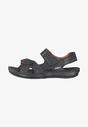 Black leather sandal featuring two adjustable Velcro straps, open toe design, and stitched accents along the sole for flexibility and comfort.