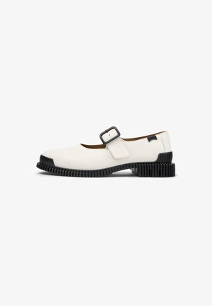 White leather shoe with a black rubber sole, featuring a decorative buckle strap and rounded toe design. Textured material and contrasting colors.