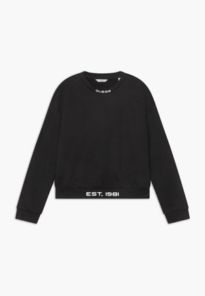 Sweat-shirt court noir en molleton avec un col rond, arborant le logo blanc "GUESS" au col et "EST. 1981" à l'ourlet.