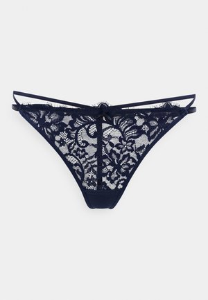Marine blonde trusse med blomsterprint, blødt mesh og solid stofblanding. Har smalle stropper og et centralt sløjfedetalje.