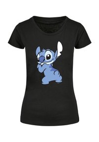 Tricou negru cu un caracter de desene animate albastru, cu urechi mari și ochi expresivi, poziționat jucăuș cu o față zâmbitoare.