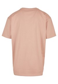 Kortærmet t-shirt med rund hals i blød lyserød stof. Simpelt design med glat overflade og ingen synlige mønstre eller detaljer.