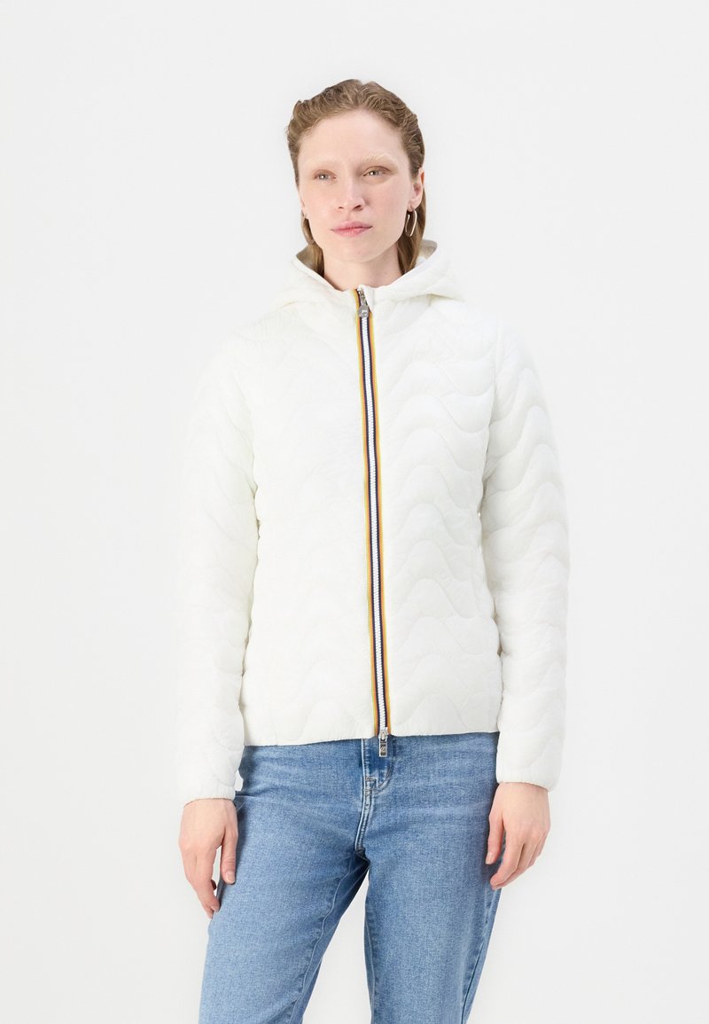 Giacca imbottita bianca con cappuccio, caratterizzata da una texture ondulata e un accento di zip multicolore. Abbinata a jeans blu.