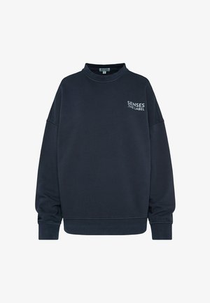 Navy blue sweatshirt made of soft fabric, featuring a high neckline, dropped shoulders, and a small white logo on the chest.