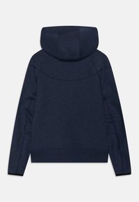 Navy blue hoodie with a soft texture, featuring a large hood and raglan sleeves. Includes subtle seam detailing and elasticated cuffs.