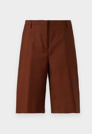 Pantalones cortos marrones a la altura de la rodilla, confeccionados a medida, con trabillas para cinturón y cierre frontal oculto sobre un fondo claro y liso.