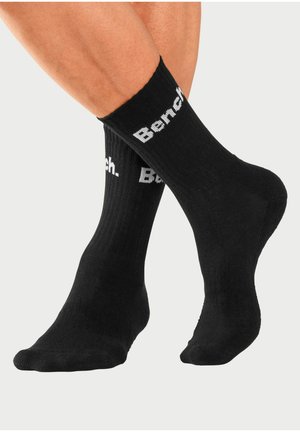 Black cotton crew socks with ribbed texture and white "Bench." logo printed on the leg. Features a standard fit and cushioned sole.