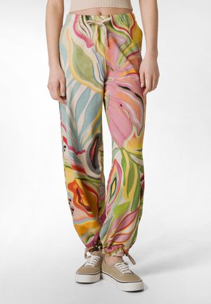 Pantalons colorés et amples avec un motif floral dans des tons de rose, vert et bleu ; poignets et taille élastiques avec un cordon de serrage.