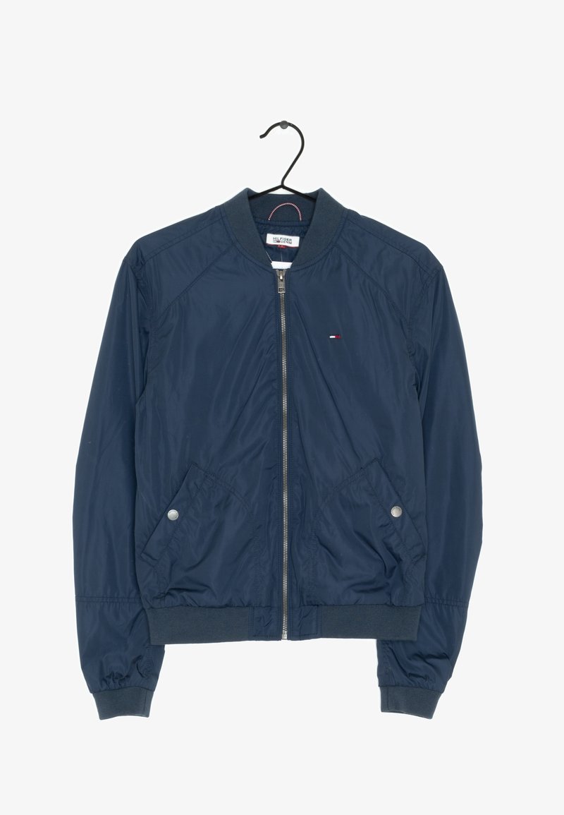 Navy blue bomber jacket with a zip front, ribbed collar, and two side pockets. Made of smooth, lightweight fabric with subtle logo detailing.