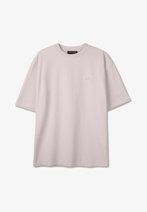 Tricou supradimensionat de culoare bej deschis, cu mâneci scurte, decolteu rotund și un mic logo grafic alb pe pieptul stâng.