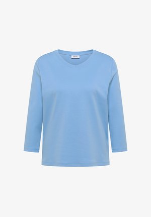 Camicia azzurro chiaro a maniche lunghe con scollo a V e etichetta "CECIL" all'interno del colletto, mostrata su sfondo bianco.