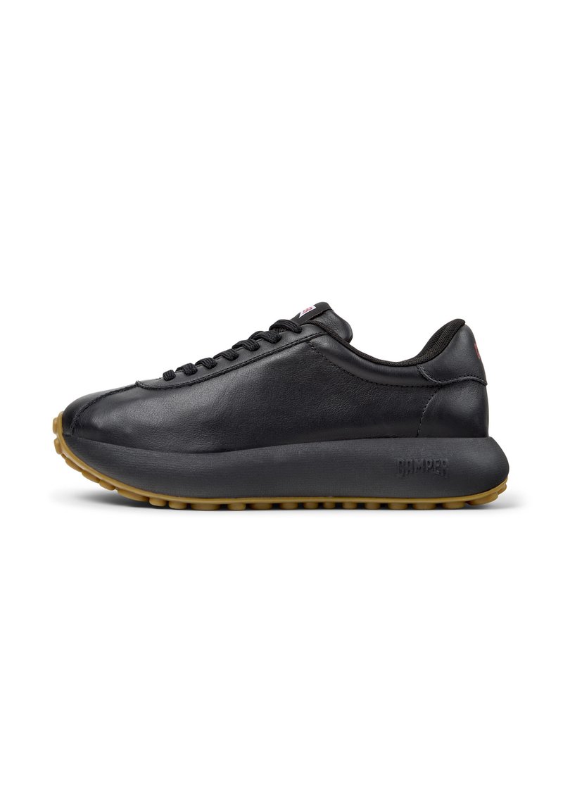 Black leather sneakers with a smooth texture, rounded toe, and a thick rubber sole. Features sleek design and subtle branding on the side.