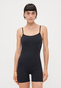 Black bodysuit with thin straps, made from smooth, stretchy material. Features a fitted design and mid-thigh length. Minimalist style.