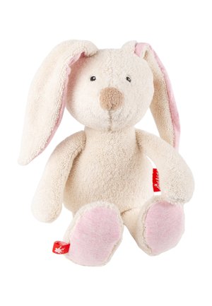 Soft cream-colored plush bunny with long ears lined in pink, pink paw pads, and a small red fabric tag on its left side.