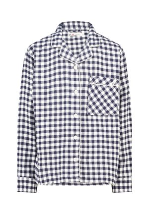 Chemise en flanelle à carreaux bleu marine et blanche avec des manches longues, fermeture à boutons, col et poche à rabat sur la poitrine gauche.