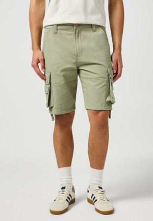 Cargo shorts in light green, made of cotton fabric, with multiple side pockets, a buttoned waistband, and a relaxed fit.