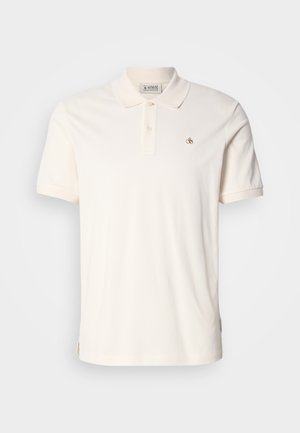Short-sleeve polo shirt in soft cream cotton, featuring a three-button placket and a small embroidered logo on the chest.