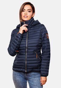 Navy blue puffer jacket with a hood, quilted design, zippered front, and two side pockets featuring brown leather accents.
