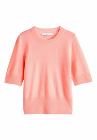 Korallna kratka majica od mekog materijala, s rebrastim izrezom i rubom. Jednostavan dizajn s opuštenim krojem.
