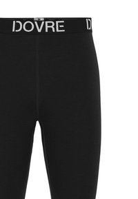 Sorte leggings lavet af blødt stof med en bred talje, der har "IDOVRE" logoet i hvidt. Indeholder flade sømme for komfort.