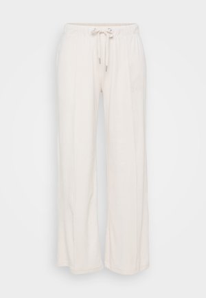 Pantalones de pierna ancha en un tono beige claro con cintura elástica y cordón. Fabricados en un material suave con costuras verticales que recorren la parte delantera.