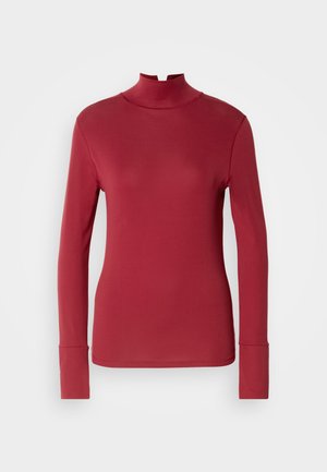 Top a maniche lunghe a collo alto di un profondo rosso, realizzato in tessuto morbido. Caratterizzato da un colletto alto e una vestibilità attillata con polsini allungati.