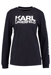 Camiseta negra de manga larga hecha de algodón, con el texto blanco "KARL LAGERFELD" en la parte frontal y un logotipo en la manga.