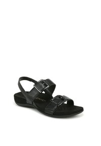 Sandales noires avec deux brides réglables, tige synthétique texturée, semelle rembourrée et semelle plate avec un léger soutien de la voûte plantaire.