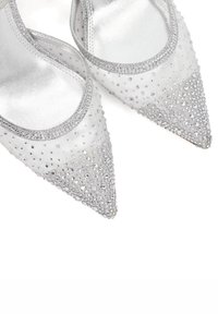 Silver-tone pointed-toe heels with a smooth satin finish, embellished with small clear rhinestones and a silver trim along the edge.