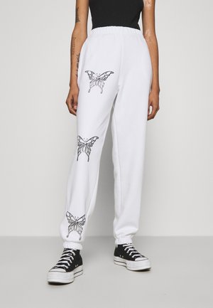 BUTTERFLY JOGGERS - Verryttelyhousut - white