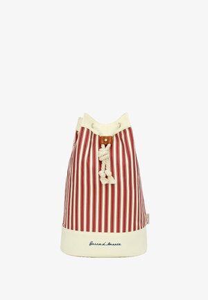 Canvas bucket bag with vertical red and white stripes, cream-colored top and base, leather accent, and drawstring closure.