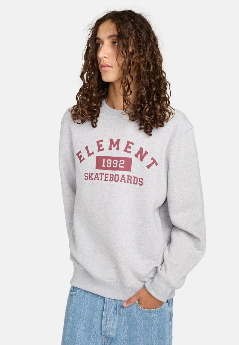 Gray sweatshirt with "ELEMENT" and "SKATEBOARDS 1992" in red print. Features ribbed cuffs and waistband, relaxed fit, soft fabric texture.