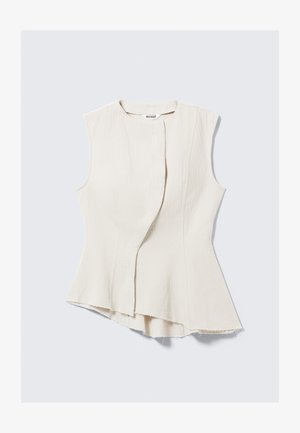 Top asimmetrico senza maniche in tessuto beige chiaro con trama, caratterizzato da un davanti incrociato discreto e orlo sfrangiato. L'etichetta riporta "WEEKDAY."