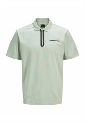 Světle zelená polokošile s krátkým rukávem a černým zipem u límce, se malým černým logem na hrudi. Hladký textilní povrch.