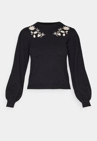 Pull noir à manches longues avec manches bouffantes et broderie florale blanche près de l'encolure sur les deux épaules.