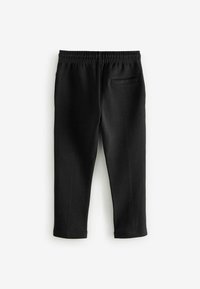 Black pants made of soft fabric, featuring an elastic waistband, cropped length, and a single back pocket. Smooth texture with no patterns.