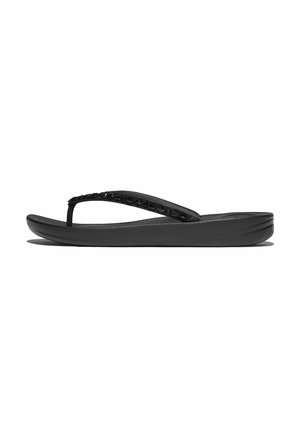 Black flip-flop sandal with a smooth rubber sole and a textured strap featuring decorative accents. Lightweight and open design.